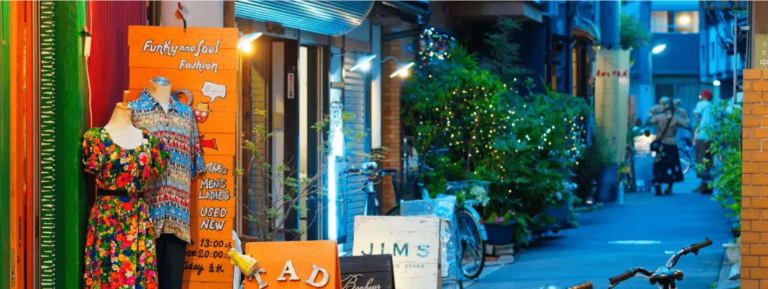 夕暮れの路地に並ぶ古着屋の看板
